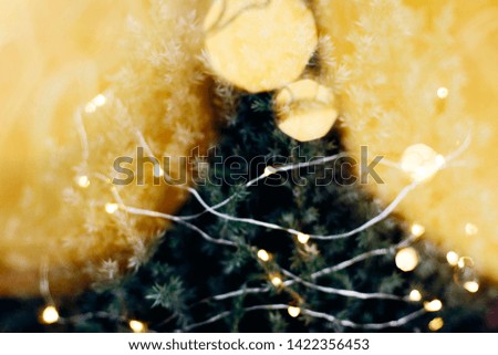A beautiful image of a bokeh from New Year's garlands. In gold colors. Defocused glitter lighting image for art and design.