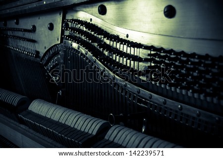 Antique piano - tuning a musical instrument. Vintage musical background - old piano inside. 