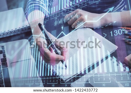 Financial chart drawn over hands taking notes background. Concept of research. Double exposure