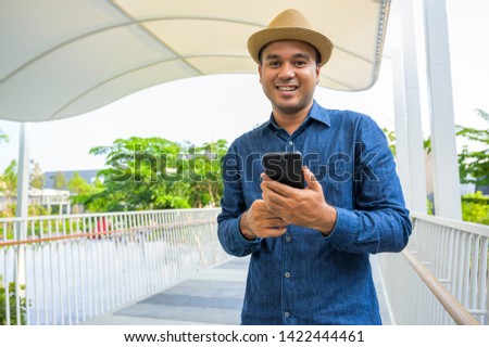Young asian man using smartphone.