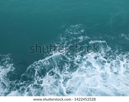 splash of water against the background of blue sea water