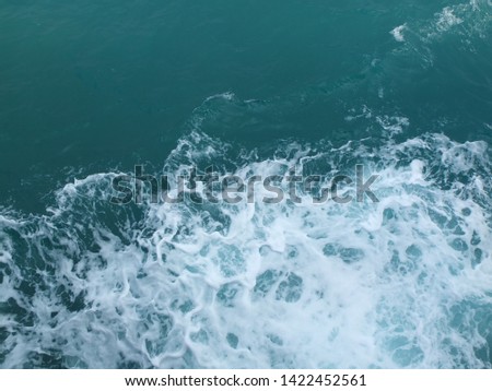 splash of water against the background of blue sea water