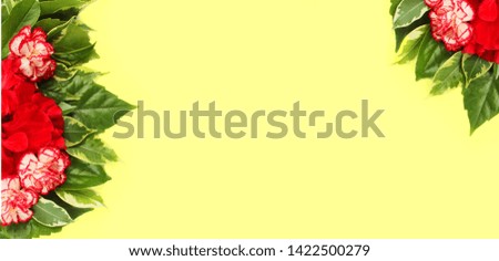 Flower arrangement of red roses and colored carnations on a yellow background. Summer bouquet. Pastel color. The view from the top. Background for greetings, wedding invitations, women's day 