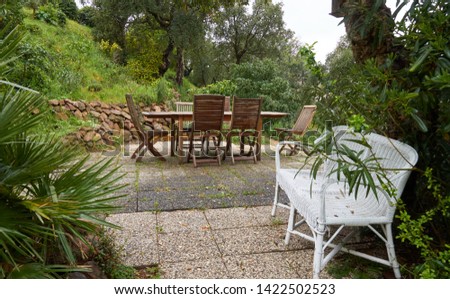 Wooden furniture in french garden in April. French Riviera, France