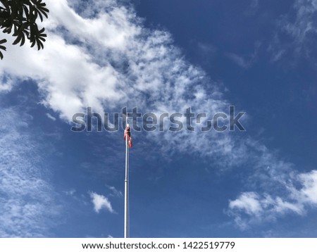 Thailand flag in white clouds and blue sky background