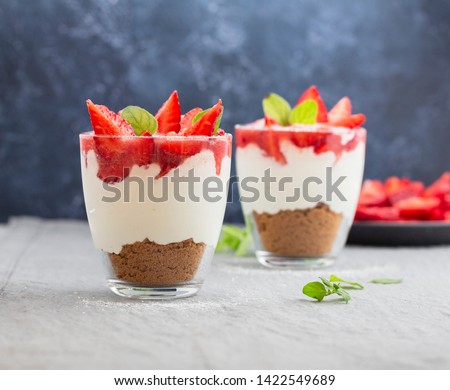 Strawberry cheesecakes in a glass on the table Royalty-Free Stock Photo #1422549689