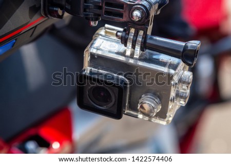 Action camera on a motorcycle rider's helmet.