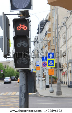 Bike route sign for cyclists outdoors at traffic light 