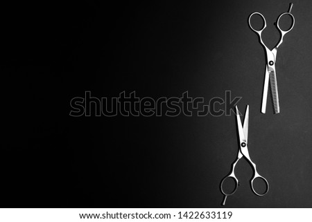 scissors for haircut, texturizing or thinning hair cutting shears, professional salon equipment on black background. Flat lay mockup