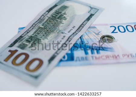 American 100 dollar banknote and 2000 russian roubles. Concept trade, cooperation or wrestling