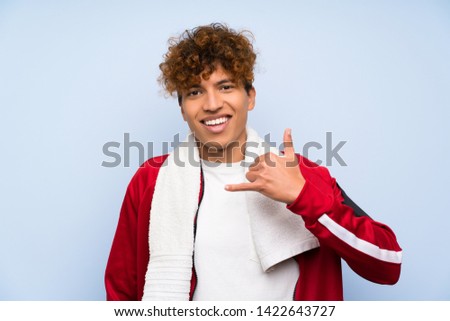 Young sport african american man making phone gesture