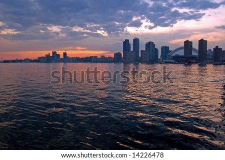 Toronto skyline from Ontario lake in time of sunset