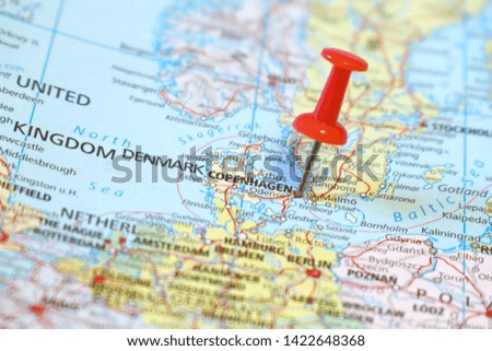 Push pin on the territory of Denmark on the world map