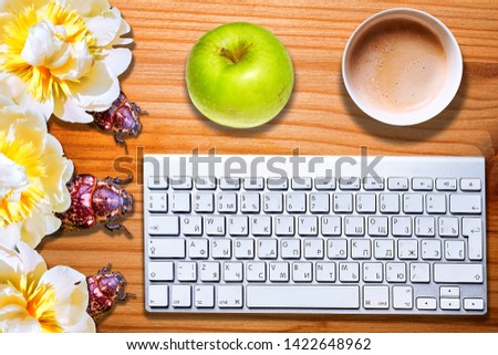 Conceptual view of computer bugs on striped wooden desk with keyboard