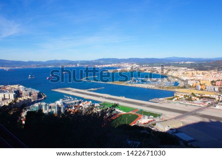 View from the Rock of Gibraltar over the airport and runway, the Spanish Border to La Linea in Spain and the mountains beyond on a clear sunny day Royalty-Free Stock Photo #1422671030