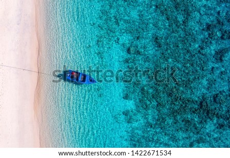 Boat on the water surface from top view. Turquoise water background from top view. Summer seascape from air. Travel - image