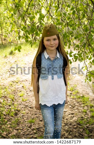 The girl in the cap is under a tree poplar.  Poplar fluff.