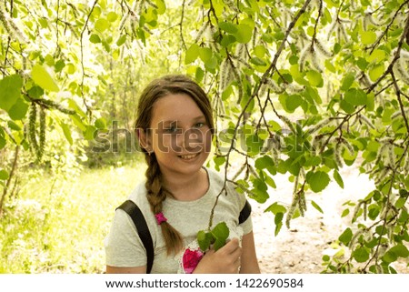 The girl in the cap is under a tree poplar.  Poplar fluff.