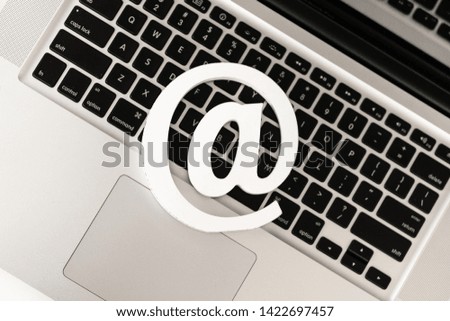 E-mail symbol on a laptop computer keyboard concept for email, communication or contact us