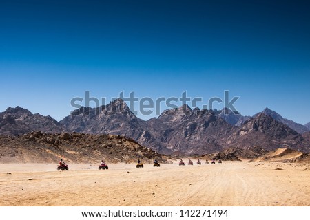 Safari Tours by quad bike in Egypt. Tourists riding quadbikes in desert.