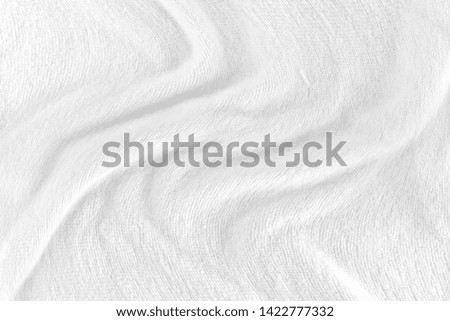 White fabric texture background with soft waves. selective focus