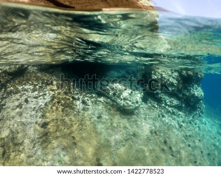 Underwater photo of tropical cave with emerald clear sea and coral reef