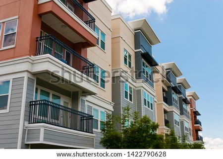 Modern luxury urban apartment building exterior with blue sky. Royalty-Free Stock Photo #1422790628