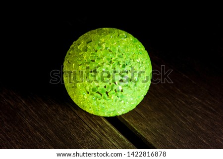 Green ball over the wood table