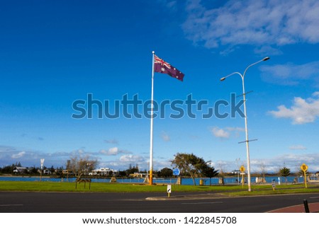 The flag of Australia is a defaced Blue Ensign, a blue field with a Union Jack in the canton (upper hoist quarter), and a large white seven-pointed  Commonwealth Star in the lower hoist quarter.