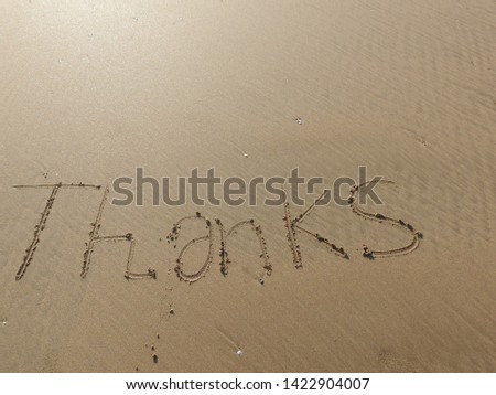 " thanks " word is written on the beach sand