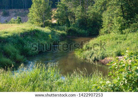 Photo of the river in the evening hour of nature in the summer on a sunny day. Beautiful dawn time.