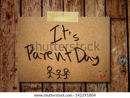 Happy parent day on note paper with wooden background