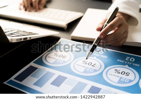 Business women reviewing data in financial statement. Accounting
