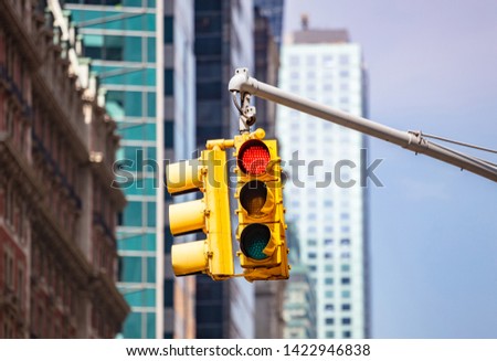 Red traffic lights for cars hanging in the city center, blur office buildings background
