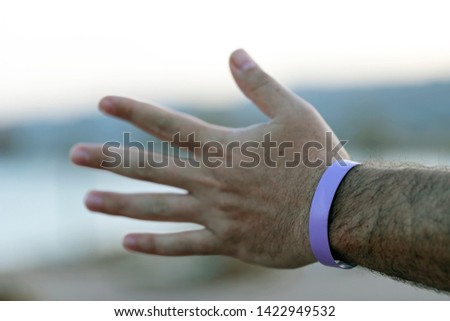 Man's hand in wristband. Holidays /vacation in hotel concept.