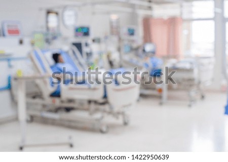 Blurred ICU room in a hospital with medical equipments and patient. 
