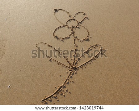 Flower symbol drawn in sand  by hand for natural, symbol,tourism or conceptual designs .