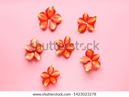 Flowers made of ripe red strawberry on color background