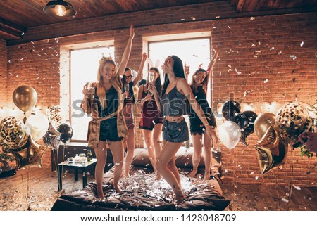 Full length body size view of nice attractive feminine lovely royal cheerful group having fun dancing on bed birthday in open space golden decorated loft industrial style interior room Royalty-Free Stock Photo #1423048709