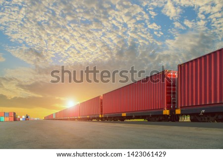 Freight Train with Cargo Containers, Transport, Shipping import Export on sunset sky background Royalty-Free Stock Photo #1423061429