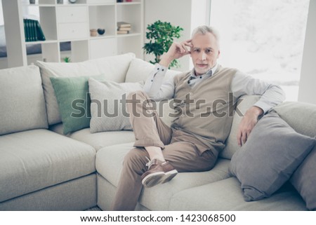 Close up photo amazing he him his aged man inspiration calm peaceful kindhearted easy-going serious look wear white shirt waistcoat pants sit cozy comfort divan bright flat house living room indoors