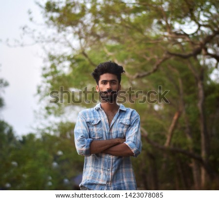 A bearded man posing different kind of forms and looks into the camera
