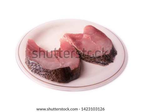 two pieces of fish in a white plate in isolation on a white background