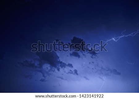 Flashes of lightning in the night cloudy sky. Thunderstorm.    
