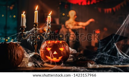 Halloween Still Life Colorful Theme: Scary Decorated Dark Room with Table Covered in Spider Webs, Burning Pumpkin, Candlestick, Witch's HatбSkeleton. In the Background Silhouette of Monster Walking By