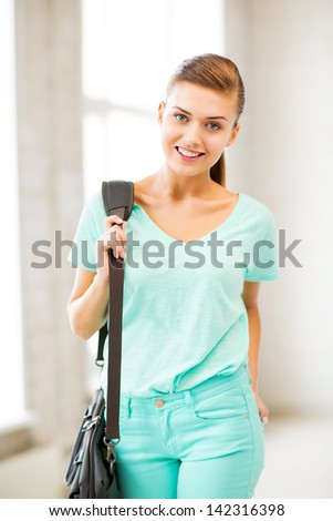 picture of happy smiling student girl with school bag