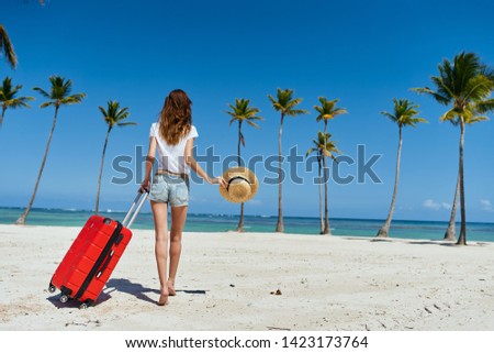 traveler with a suitcase and island tourism tropics summer palm trees                 