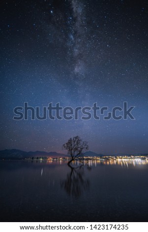 Photo of that wanaka tree , taken at 3 am , with the milky way oriented vertically  and reflected on the lake. the water was so clear that i could see the rocks beneath. South New Zealand
