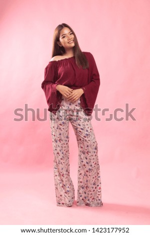 Full body of beautiful young asian woman on pink background