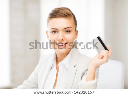 bright picture of smiling businesswoman showing credit card